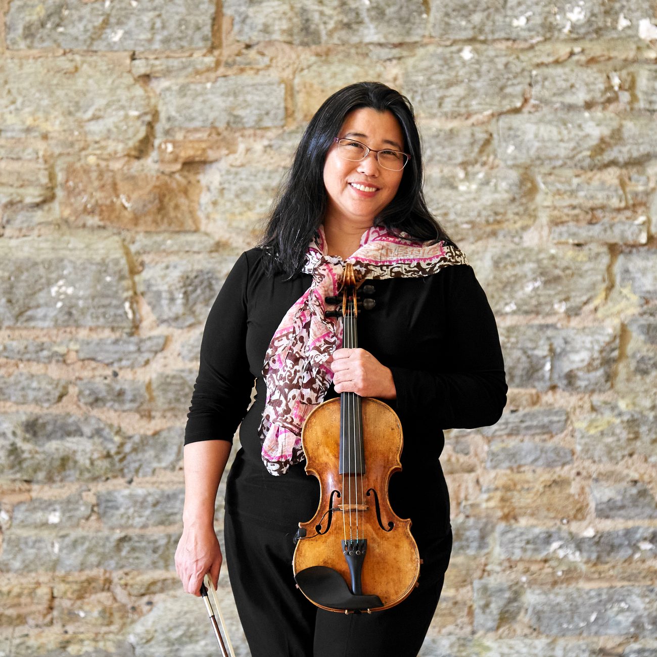 Laura Harada holding her violin